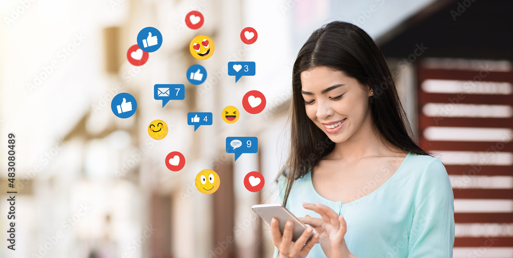 Φωτογραφία Smiling millennial asian woman surfing in internet in social networks and blog,