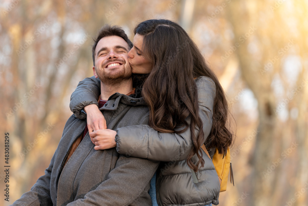 Young heterosexual couple kissing in a park on valentine's day Stock ...