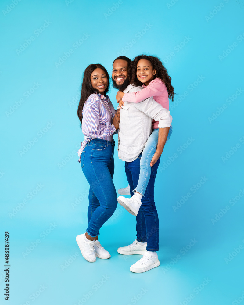 African American dad giving piggyback ride to his daughter African American dad giving piggyback ride to his daughter