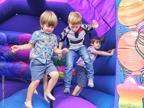 Children jumping in bouncy castle photo