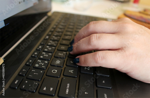 Woman is writing on her black notebook