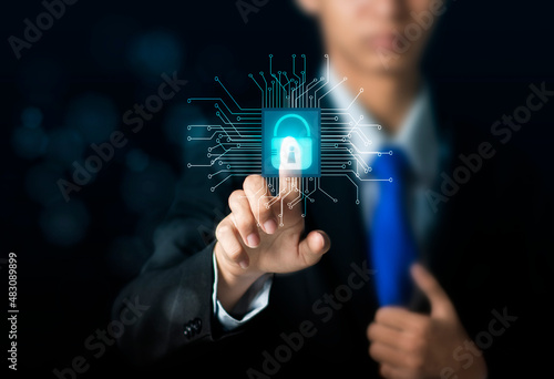 Man holding padlock and pointing finger at padlock with padlock. Businessman connecting padlock on devices. Cybersecurity service and antivirus concept. Modern simplified information chip concept.