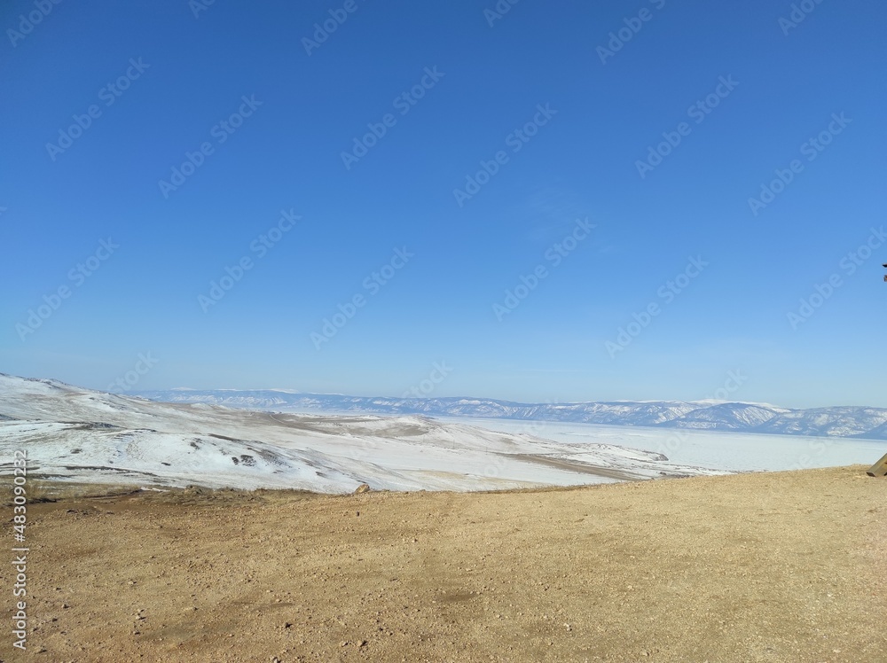 ground with snow against the blue sky