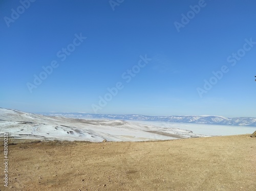 ground with snow against the blue sky