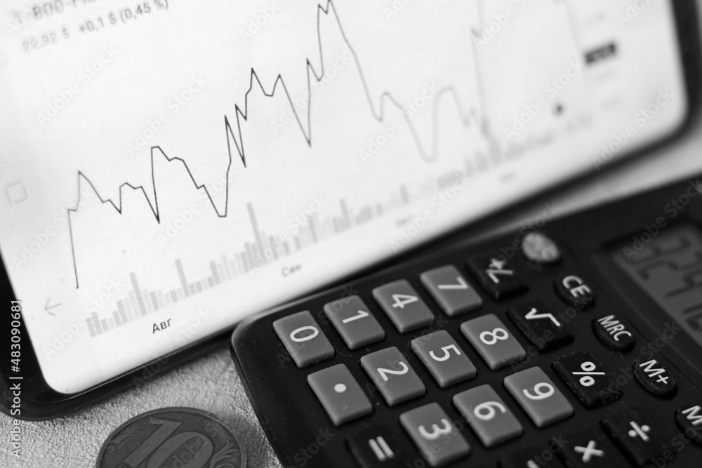 The financier counts the profit on the calculator The financier counts the profit on the calculator