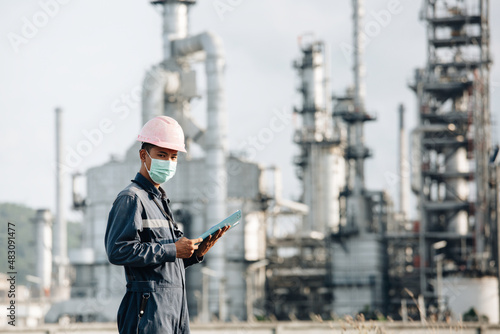 Male workers do inspection and record process refinery at industrial