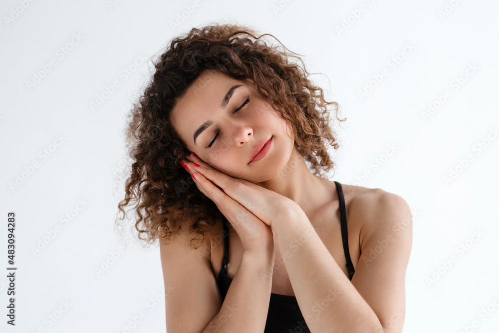beautiful curly-haired girl falls asleep on her palms