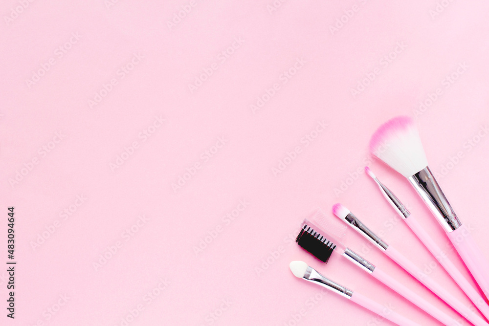 Cute pink makeup brushes on a delicate background. Flat lay, copy space. top view Cute pink makeup brushes on a delicate background. Flat lay, copy space. top view