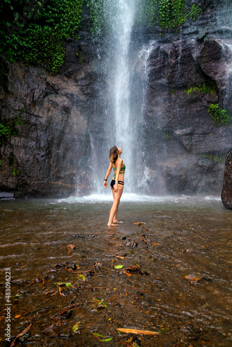 Tourist woman near Munduk waterfall  Bali  Indonesia