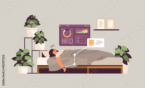 young woman sleeping in bed with electronic smart watch app tracker on hand quality and quantity sleep control