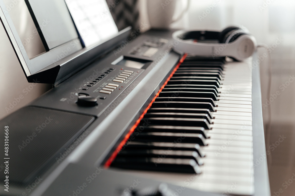 Electric piano keyboard, soft focus. Headphones on electronic piano. Electric piano keyboard, soft focus. Headphones on electronic piano.