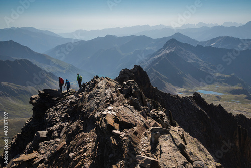 Mountaineers on the summit of the Corno dei Tre Signori mountain, Italian alps, Stelvio National Park, Lombardy.