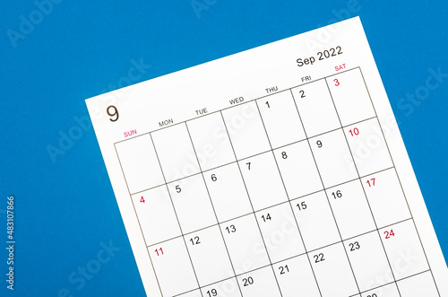 September 2022 calendar sheet on blue background. © gamjai
