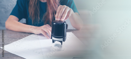 woman leaves stamp on paper