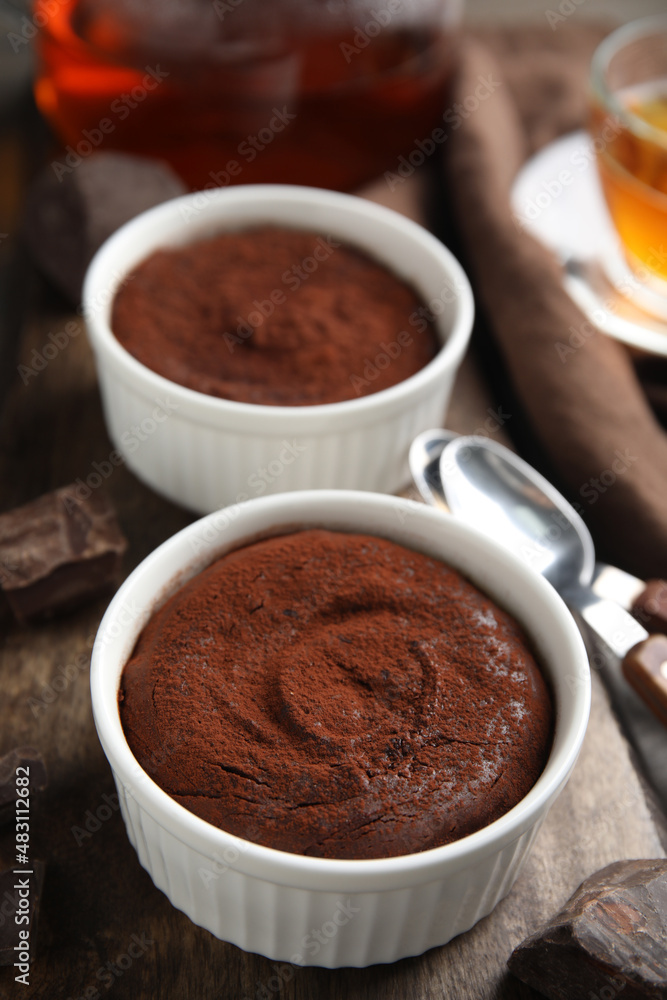 Delicious fresh chocolate fondant on wooden board Delicious fresh chocolate fondant on wooden board