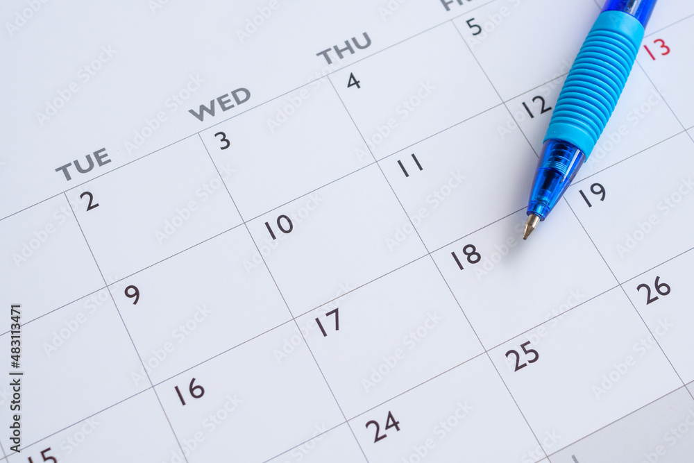 Blue pen on calendar page background business planning appointment meeting concept Blue pen on calendar page background business planning appointment meeting concept
