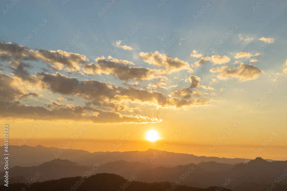 Fototapeta premium Sunset or sunrise mountain peaks colorful sky. Colorful Sky At Sunset Dawn Sunrise. Sun Over Skyline, Horizon. Warm Colours.