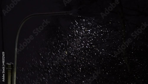 Night snowfall - snowflakes fly in the light of a street lamp - they whirl and swirl in the wind, change direction and speed, and it looks like a dance.