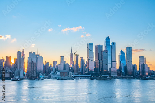 Stunning sunrise over Manhattan skyline with saturated colors and sun rays camping from the sun. © Stock fresh 