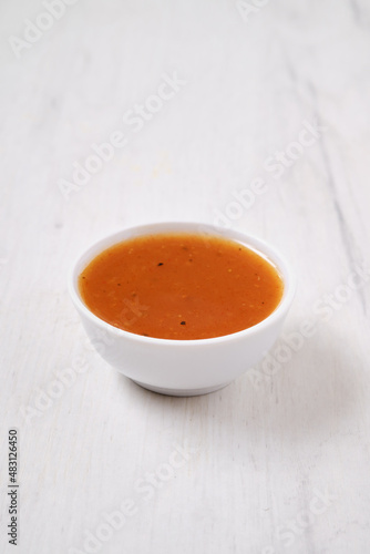 Small bowl with spicy orange sauce