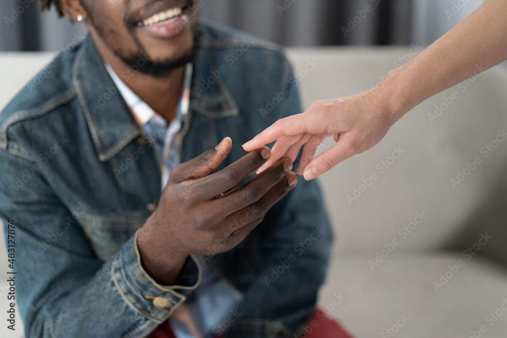 Interracial couple tender touch of a two hands. African american handsome man holding white woman hand. Interracial love concept. Love concept. Close up Interracial couple tender touch of a two hands. African american handsome man holding white woman hand. Interracial love concept. Love concept. Close up