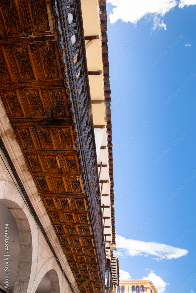 Wooden balcony in traditional street in Cusco Peru. Colony style architecture in Peruvian Andes.