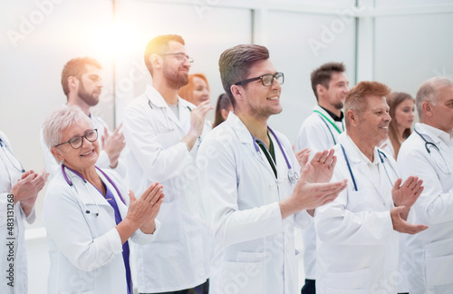 large group of medical practitioners applauding together.