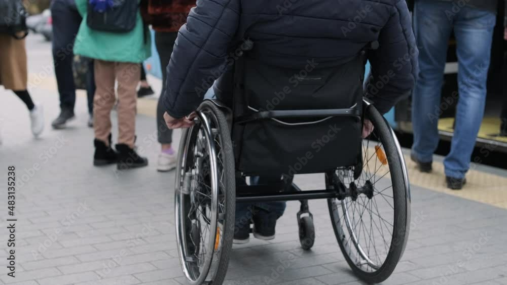 Person with a physical disability enters public transport with an accessible ramp Person with a physical disability enters public transport with an accessible ramp