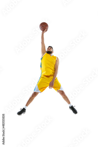 One professional basketball player practicing isolated on white studio background. Sport, motion, activity, movement concepts.