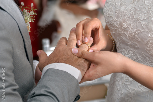 фотографія Wedding rings, hands of a bride and a groom