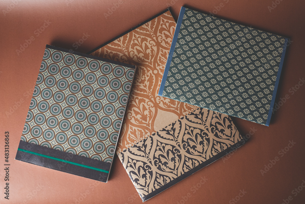 Obraz premium blue and brown notebooks with geometric and oriental ornaments 
