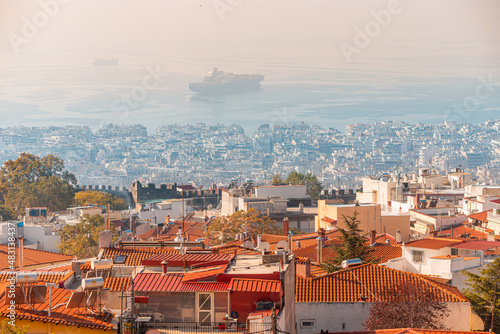 Aerial view of the city of Thessaloniki and cargo ship at the sea port from the observation deck in the upper town of AnoPoli.