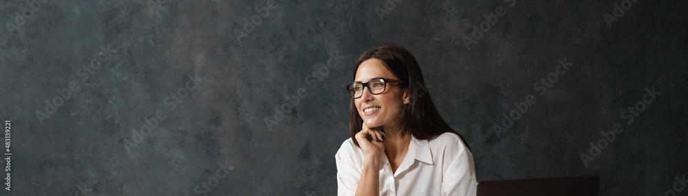 Smiling mid aged brunette woman architect working Smiling mid aged brunette woman architect working