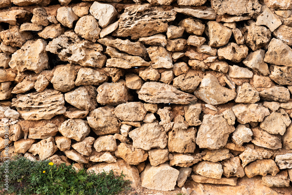 Brown nature stone wall of a local farmland Brown nature stone wall of a local farmland