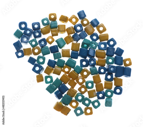 Pile of blue and yellow beads on white background, top view