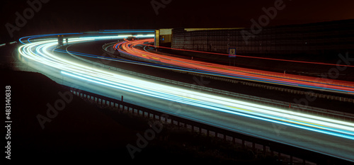 Night road lights. Lights of moving cars at night. long exposure red, blue, green, orange.