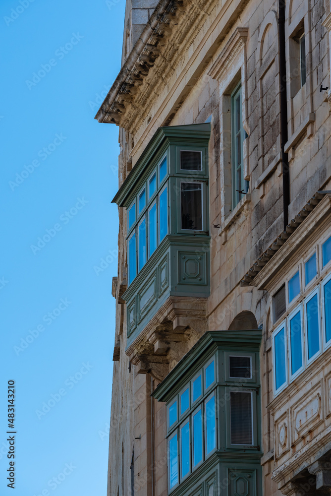 Valletta, Malta - 01 06 2022: Detail of a traditional facade with a blue sky background