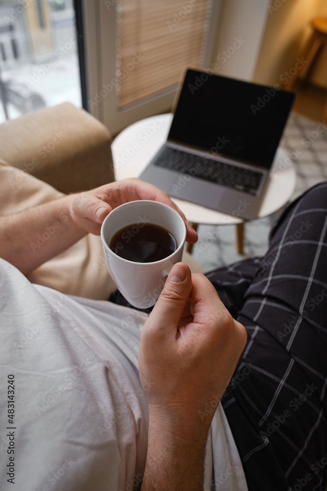 A man works with a laptop at home or in hotel. Remote work. Office at home. A man is typing on a laptop, distance learning for students, surfing the Internet. Business concept A man works with a laptop at home or in hotel. Remote work. Office at home. A man is typing on a laptop, distance learning for students, surfing the Internet. Business concept