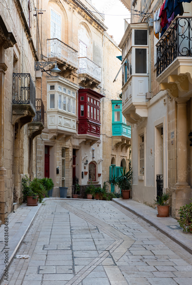 Valletta, Malta - 01 06 2022: Narrow street with residential houses in Mediterranean style
