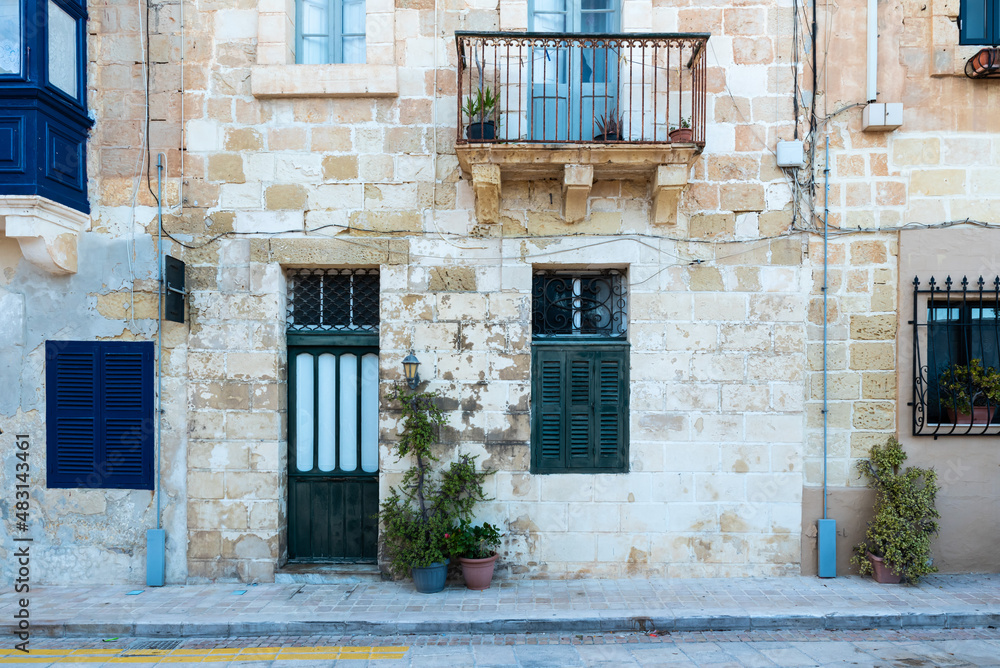 Valletta, Malta - 01 06 2022: Traditional facade of residential houses in Mediterranean style