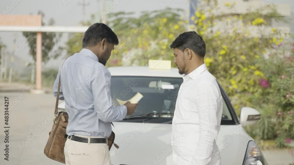 cab driver receiving check from banker in front of car - concept of car loan, financial support from bank and starting new business cab driver receiving check from banker in front of car - concept of car loan, financial support from bank and starting new business