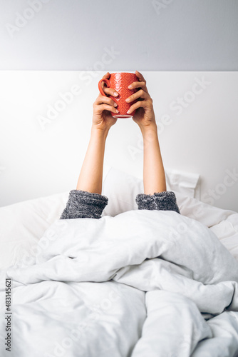 Fotografija Hands of a woman holding a cup of coffee in the morning upon waking up
