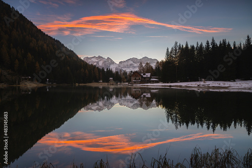 Sky at sunrise reflected in the lake Nambino, Madonna Di Campiglio, Trentino, Italy. © Andrea
