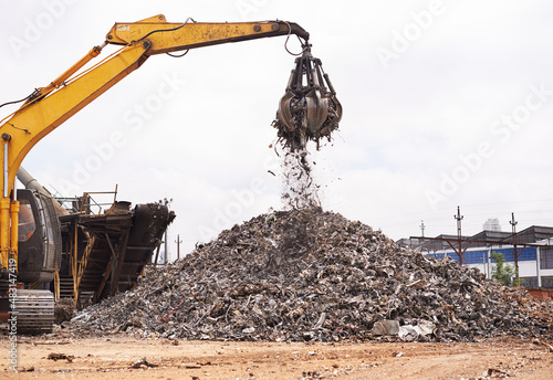 Industrial re-purposing. Cropped shot of an excavator sorting through a pile of scrap metal.