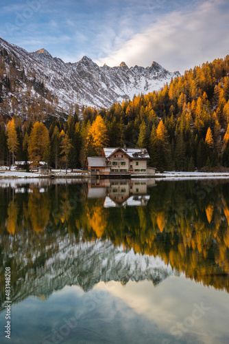 Autumn landscape of lake Nambino with hute, Madonna Di Campiglio, Trentino, Italy.