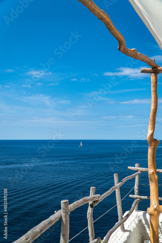 Wood railing with ocean views in Alaior, Menorca (Spain).