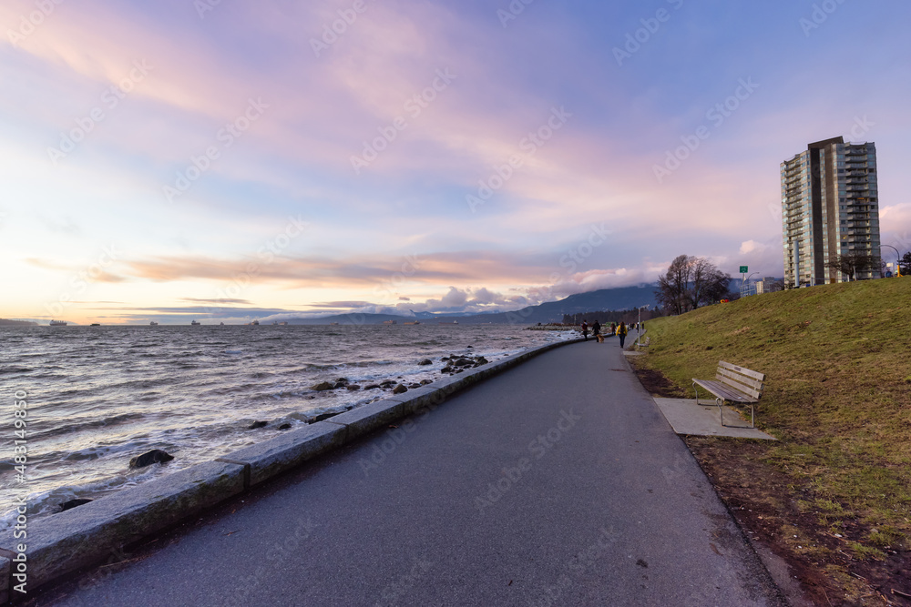 Seawall in Downtown Vancouver, British Columbia, Canada. Colorful Winter Sunset. Modern City on the Pacific Ocean West Coast.