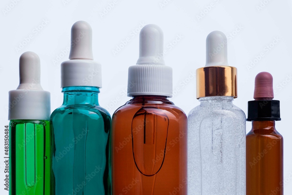 Cosmetic assortment of serum or oil pipette bottles on white background Cosmetic assortment of serum or oil pipette bottles on white background