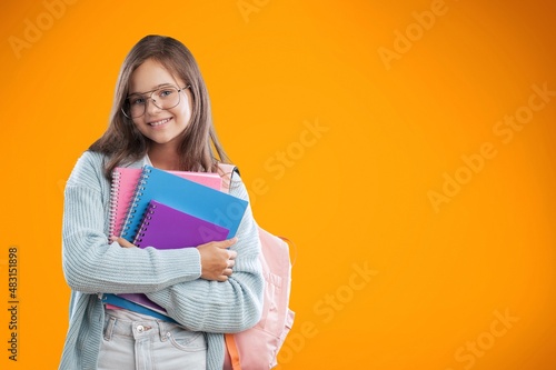 Young happy smart teenager schoolgirl pupil student wearing bag going back to school
