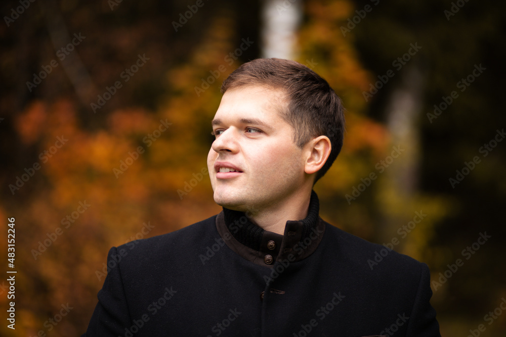 man with jacket outdoors smiling looking to the side taking a selfie on location man with jacket outdoors smiling looking to the side taking a selfie on location
